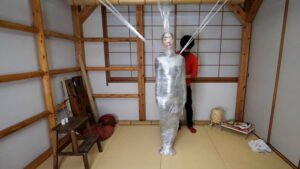 Fetish mummification for Hinako with Plastic Wrap creating a spider web style Part 2