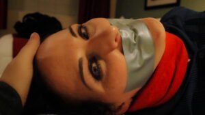 Caroline wriggles in pleasure bound and gagged on the bed