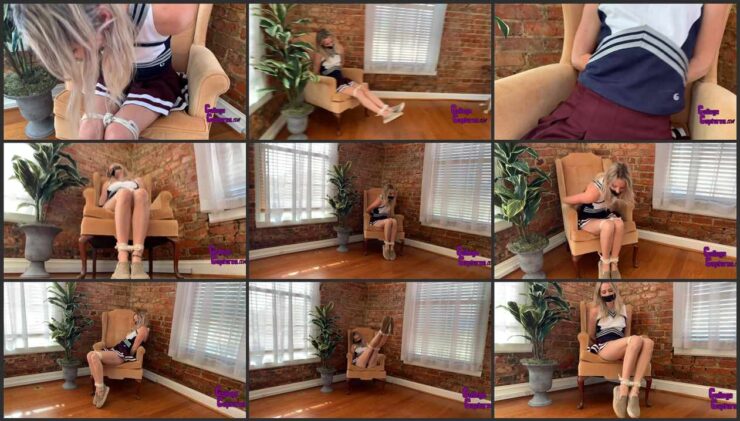 Cheerleader Kody tied up on a chair with a taped mouth