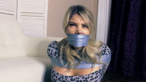 Blonde Carissa in a heavily taped tries to free herself