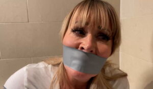 Jamie bound and wraparound tape gagged in the bathroom