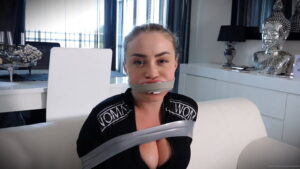 Aubrey in Jumpsuit tied struggling on the sofa 3 Gag Video