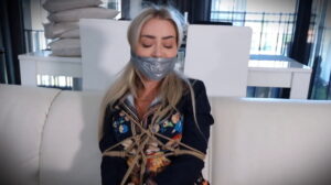 Sexy Lady Aubrey in Rope Bondage struggles on the sofa
