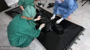 Surgical procedure with thsree cruel women in a latex vacuum bed