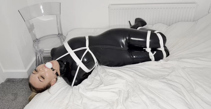 Agent Hoskins get captured in Latex Catsuit