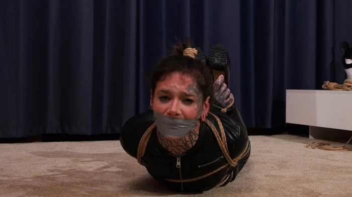 Hogtied and hairtied in leather