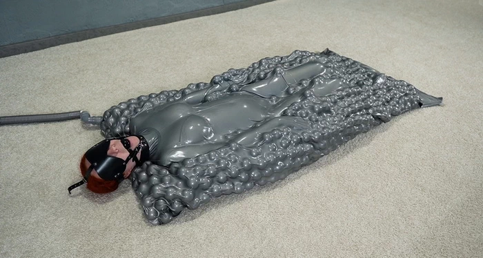 Gray vacuum bed with mask balls and gag