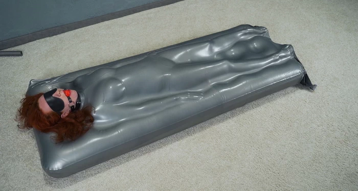 Sonya gagged in a gray vacuum mattress bed