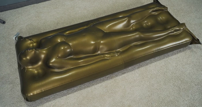 Sonya in a gold vacuum bed on a vibro mattress