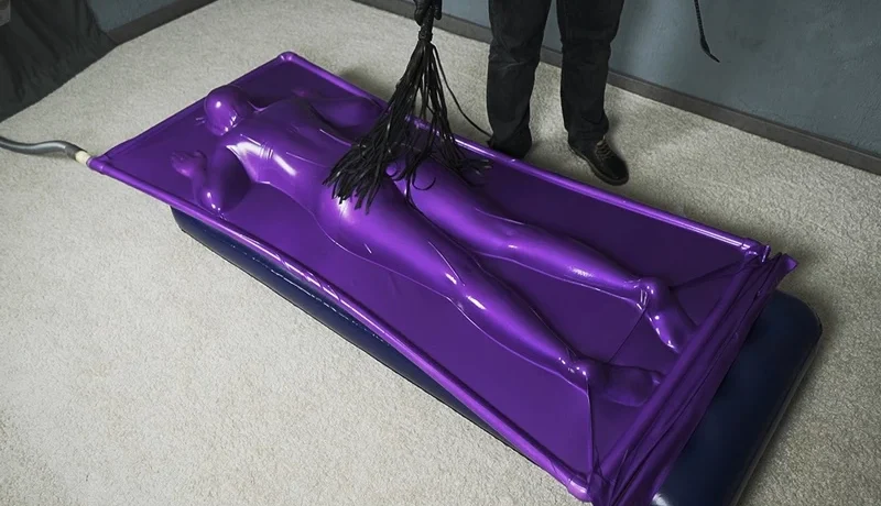 Butt flogging on a mattress in a purple vacuum bed