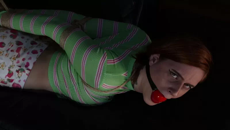 Hogtied and ballgagged on the couch