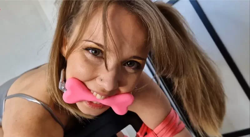 Silver bodysuit tied bent over stool