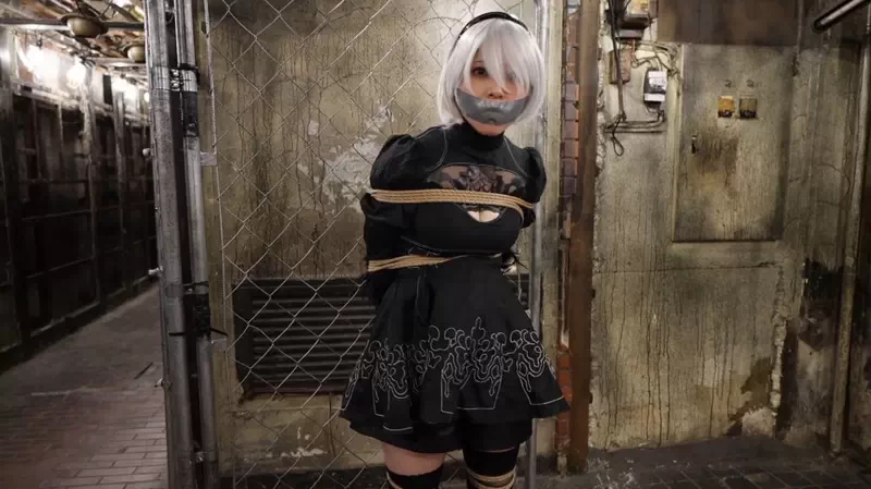 A videogame cosplayer tied up and gagged in an abandoned tunnel