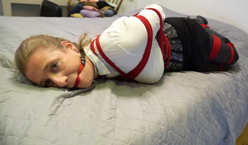 Dina bound and ballgagged in boots